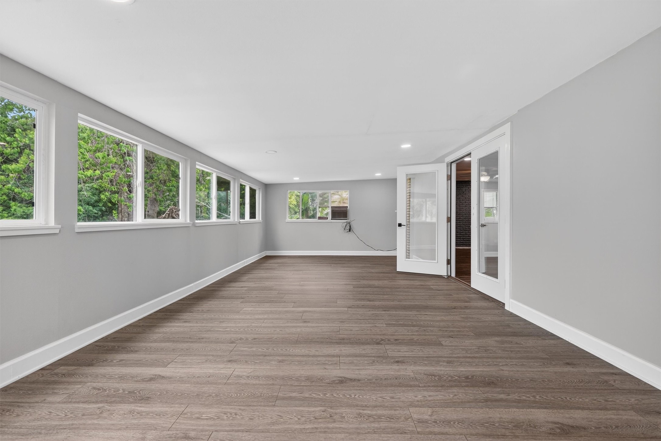 379 Hale Road Bay City, TX 77414 - Photo 13 of 28 a view of an empty room with a window and wooden floor