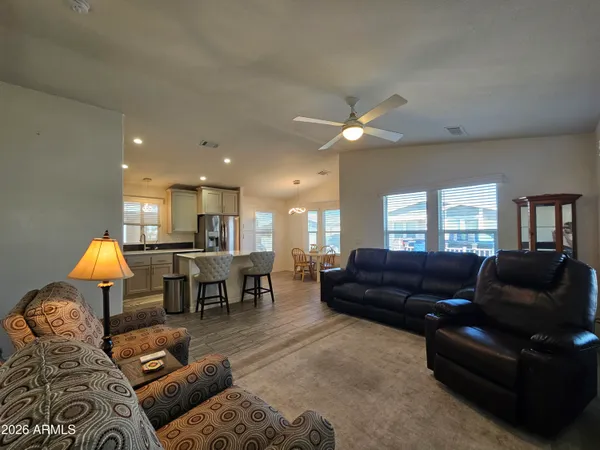 a living room with furniture and a dining table