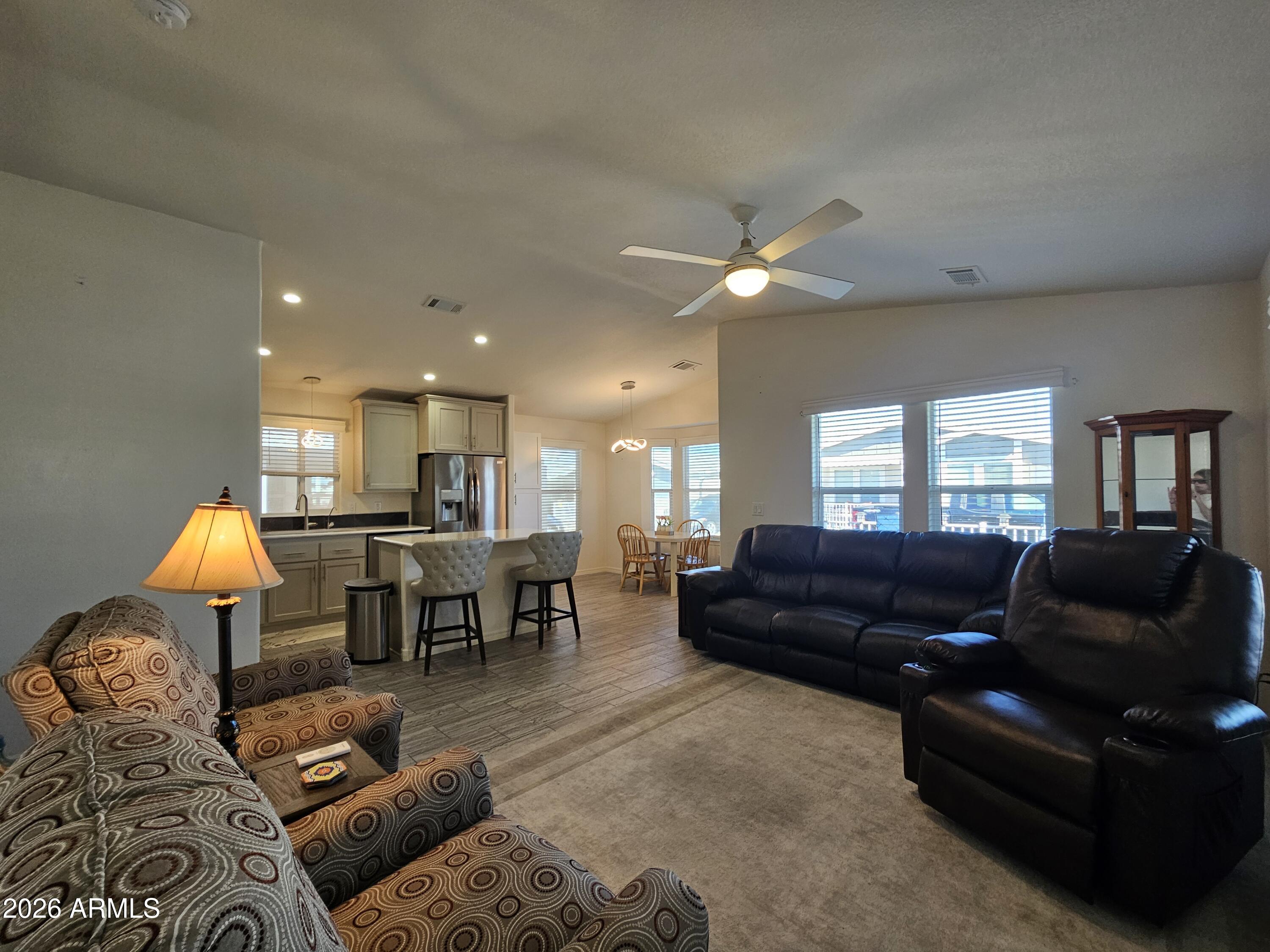 650 North Hawes Road, Unit 3223 Mesa, AZ 85207 - Photo 1 of 39 a living room with furniture and a dining table