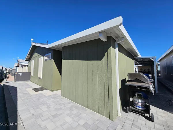 a kitchen with stainless steel appliances granite countertop a refrigerator a stove a sink dishwasher and a refrigerator with wooden floor