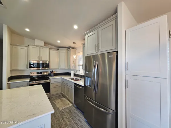 a kitchen with kitchen island a appliances and wooden cabinets