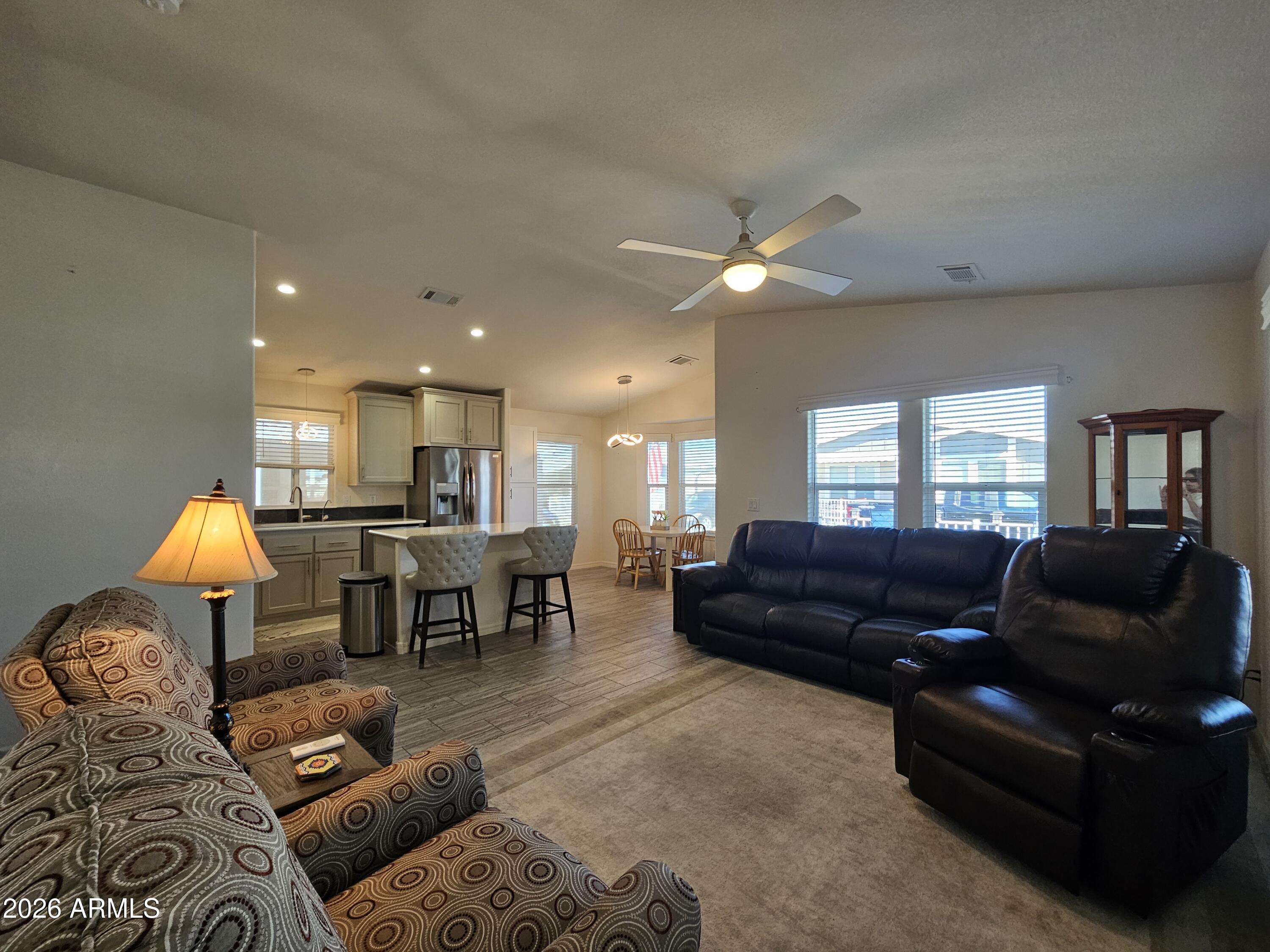 650 North Hawes Road, Unit 3223 Mesa, AZ 85207 - Photo 17 of 39 a living room with furniture and a dining table with kitchen view