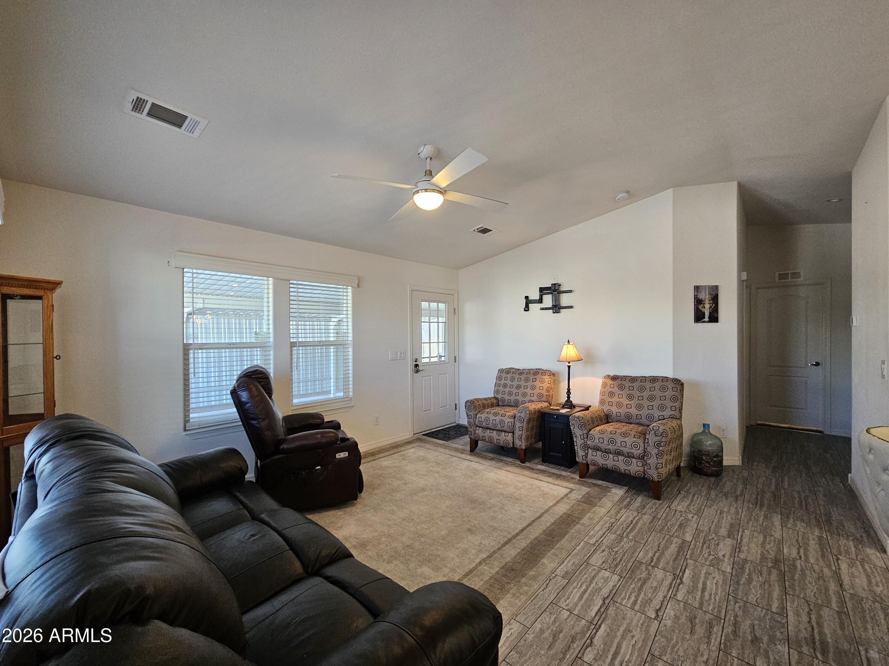 650 North Hawes Road, Unit 3223 Mesa, AZ 85207 - Photo 18 of 39 a living room with furniture a couch and a chandelier