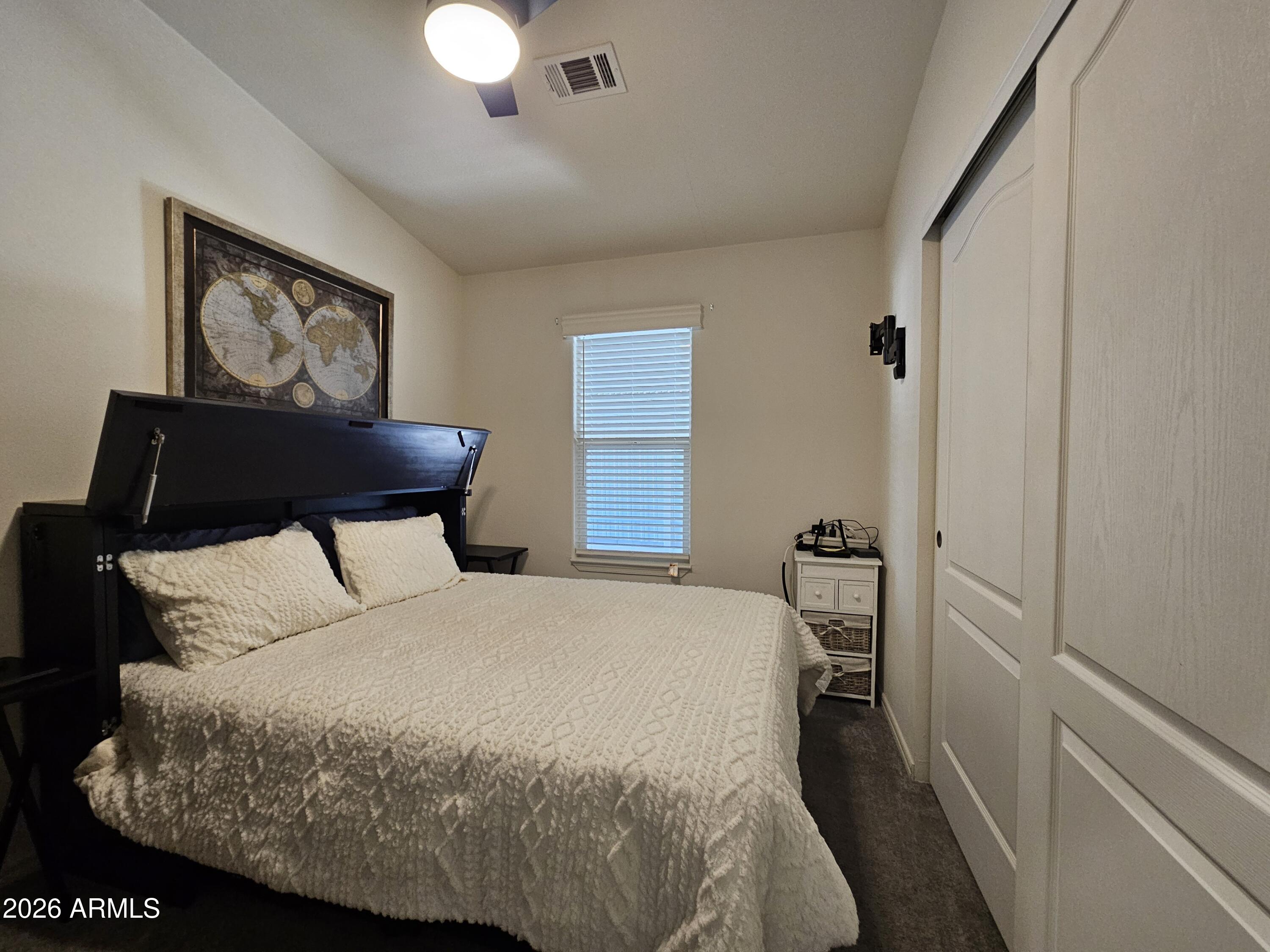 650 North Hawes Road, Unit 3223 Mesa, AZ 85207 - Photo 20 of 39 a bedroom with a bed and a painting on the wall