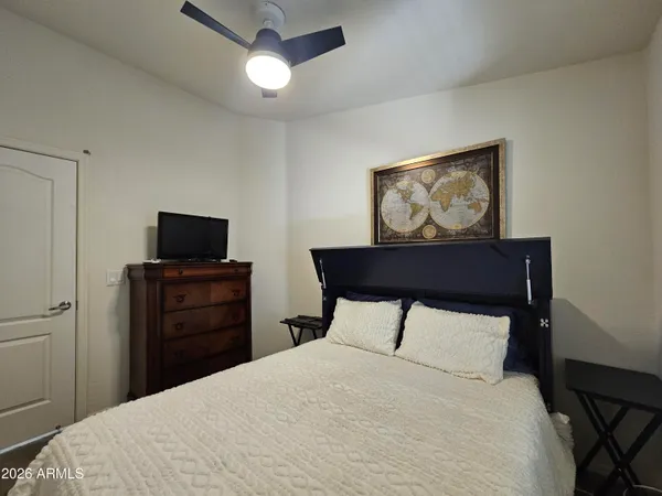 a bedroom with a bed and a flat screen tv