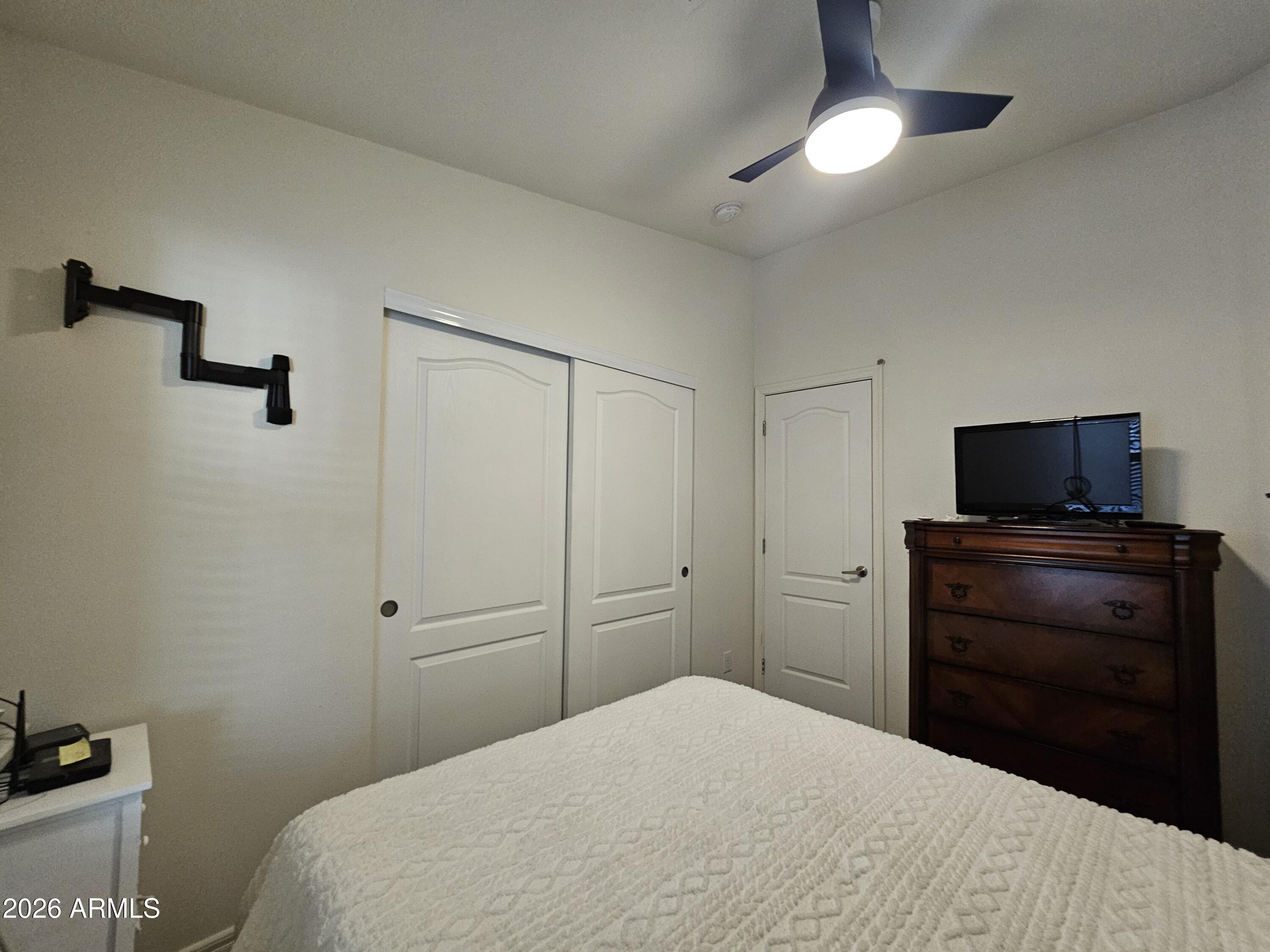 650 North Hawes Road, Unit 3223 Mesa, AZ 85207 - Photo 22 of 39 a bedroom with a bed and a flat tv screen on a dresser
