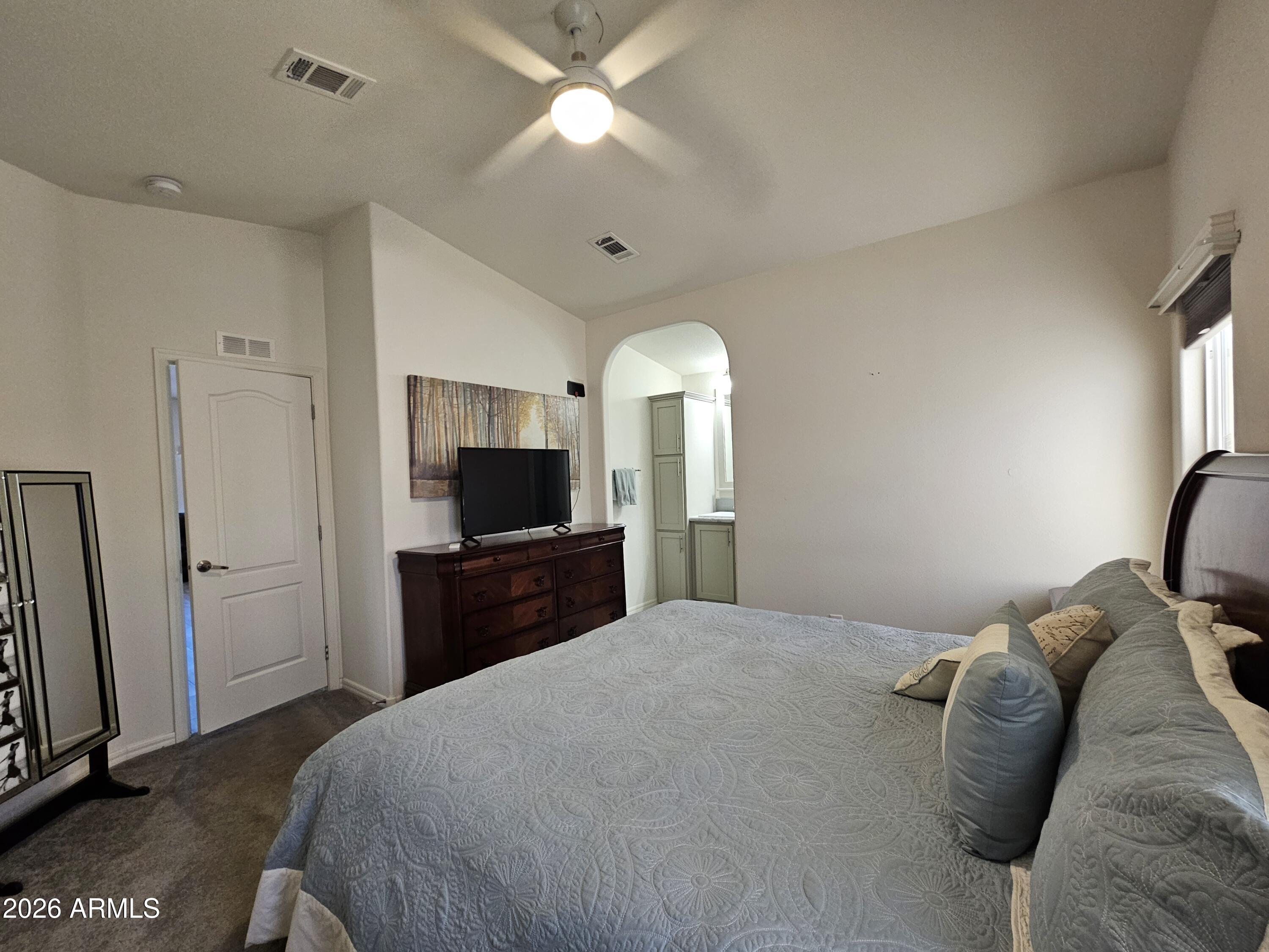 650 North Hawes Road, Unit 3223 Mesa, AZ 85207 - Photo 23 of 39 a bedroom with a bed and a flat screen tv