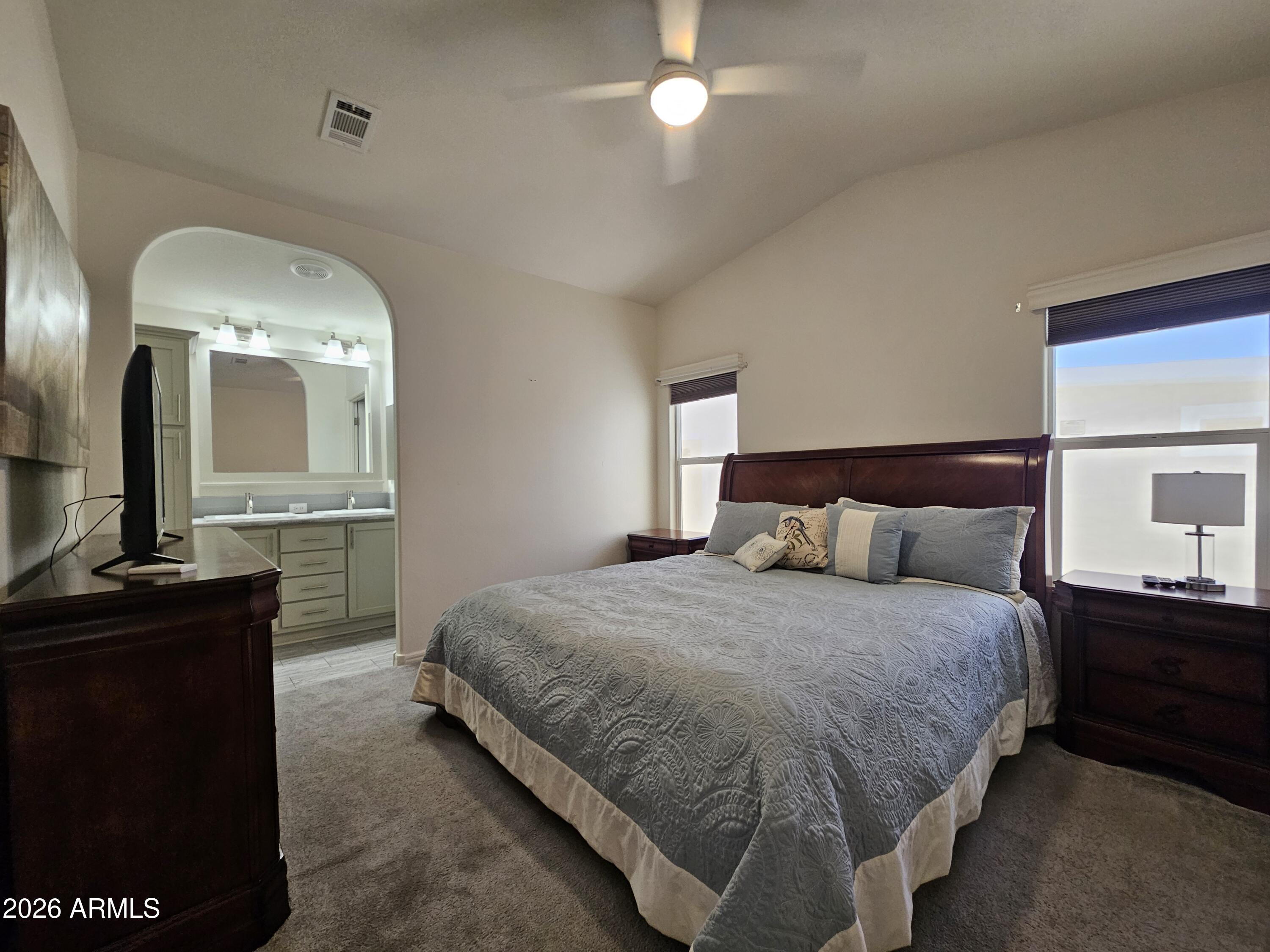 650 North Hawes Road, Unit 3223 Mesa, AZ 85207 - Photo 4 of 39 a bedroom with a bed and a mirror