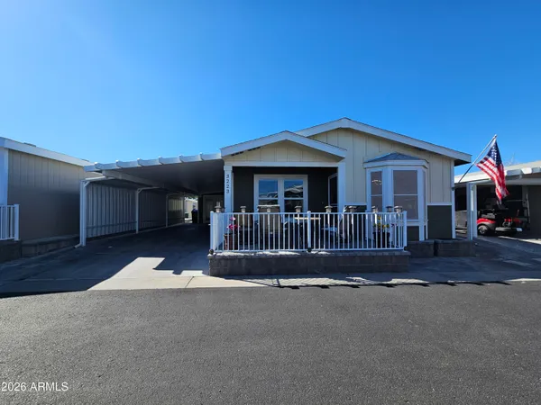 a balcony with wooden floor table and chairs