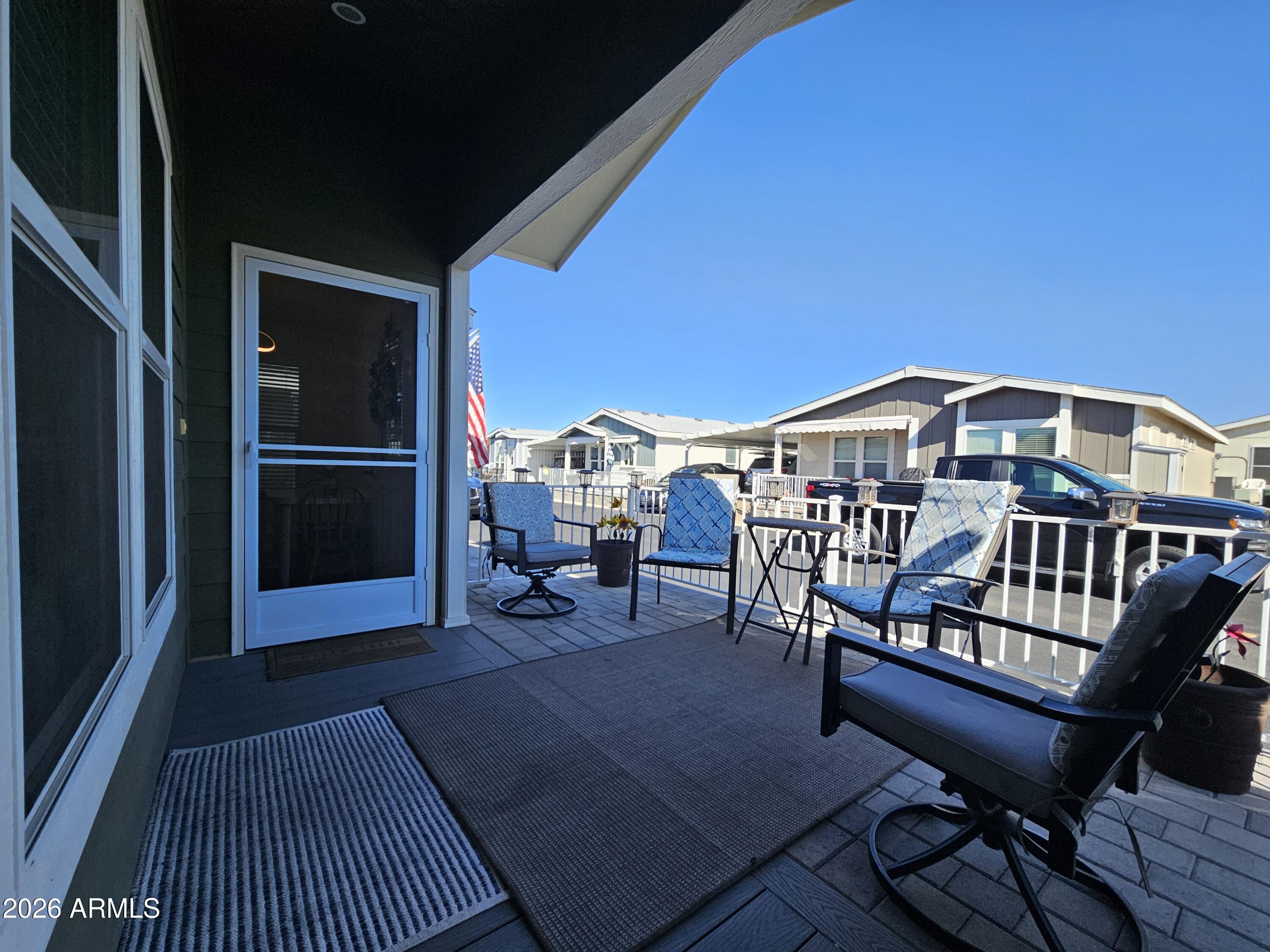 650 North Hawes Road, Unit 3223 Mesa, AZ 85207 - Photo 7 of 39 a balcony with wooden floor table and chairs