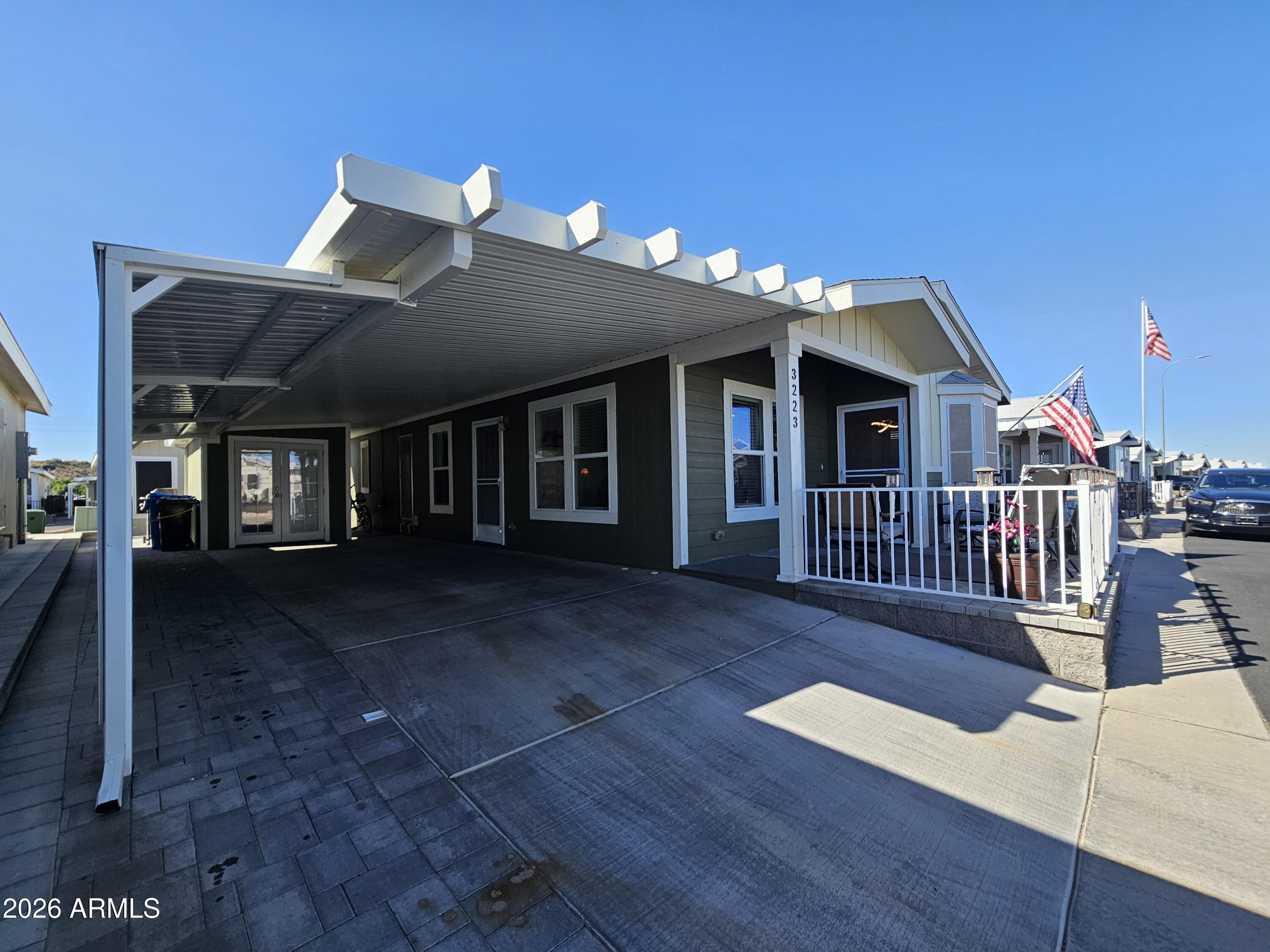 650 North Hawes Road, Unit 3223 Mesa, AZ 85207 - Photo 9 of 39 a view of a livingroom with porch and wooden floor