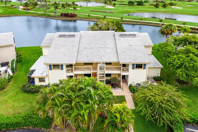 an aerial view of a house with a yard table and chairs