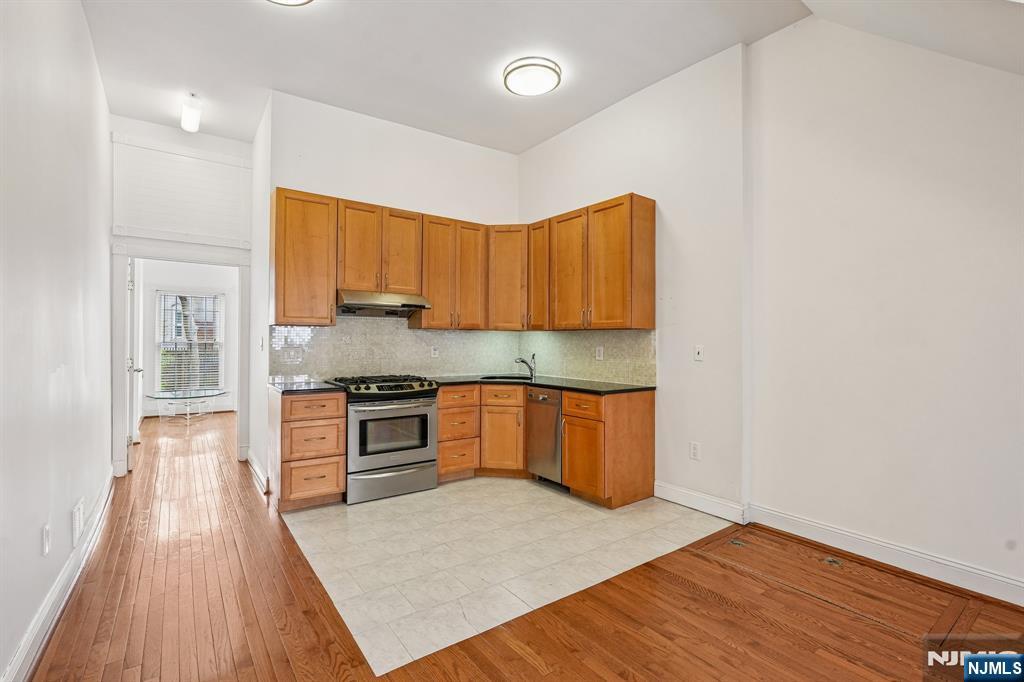 90 A Hackensack Plank Road Weehawken, NJ 07086 - Photo 13 of 40 a kitchen with granite countertop a stove a sink and a refrigerator