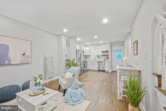 a living room with furniture kitchen and a table