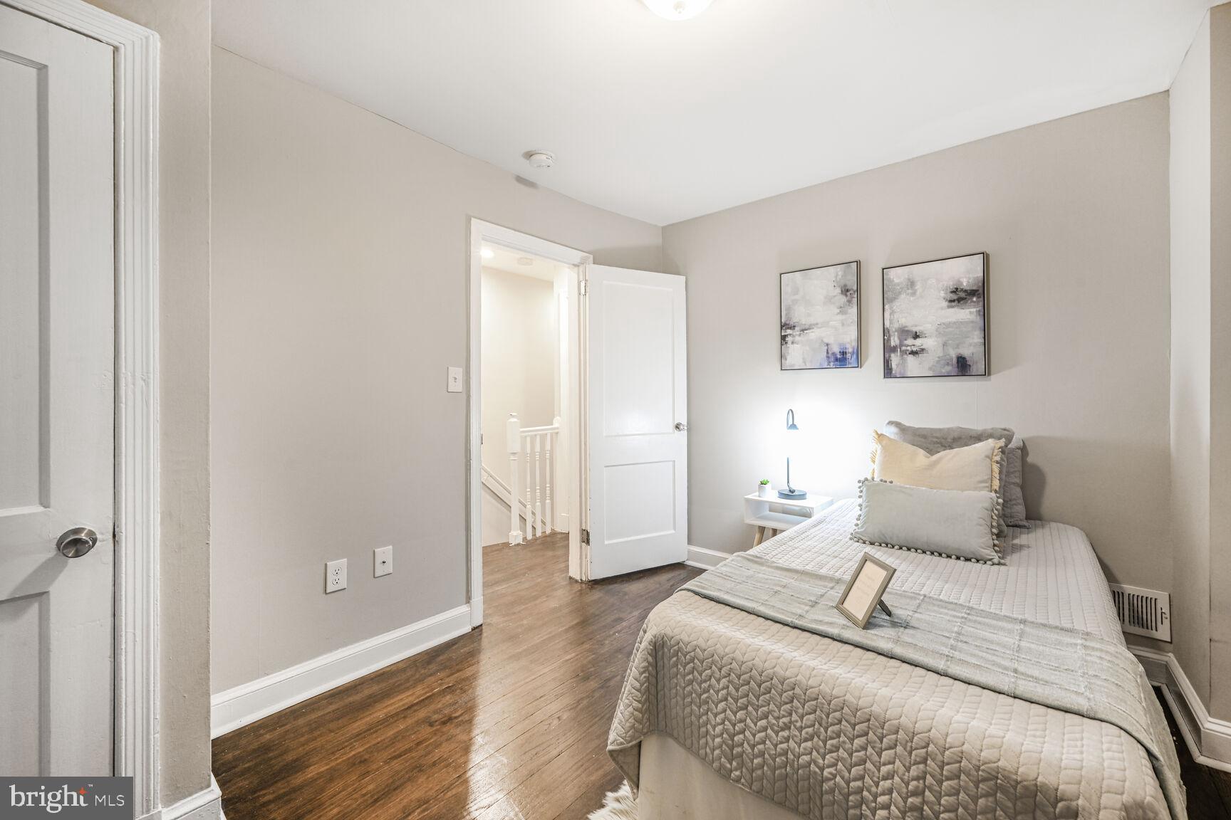 1459 Morris Road Southeast Washington, DC 20020 - Photo 12 of 25 a bedroom with a bed and wooden floor