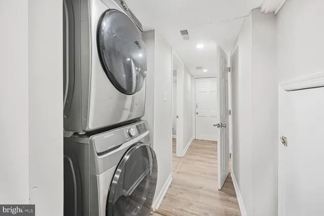a view of a hallway with washer and dryer