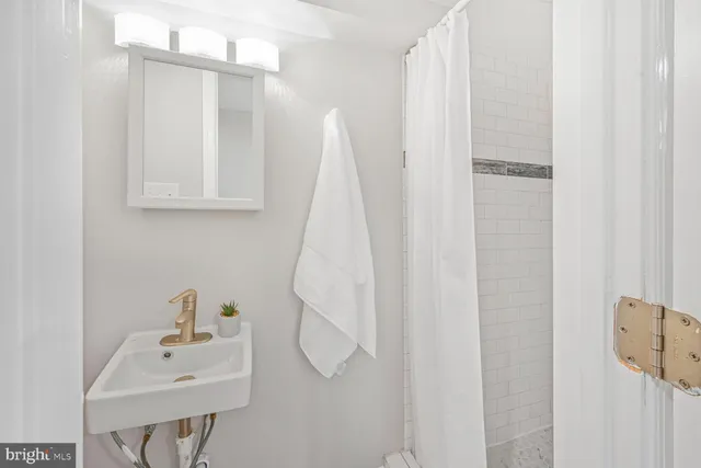 a bathroom with a sink a mirror and a shower