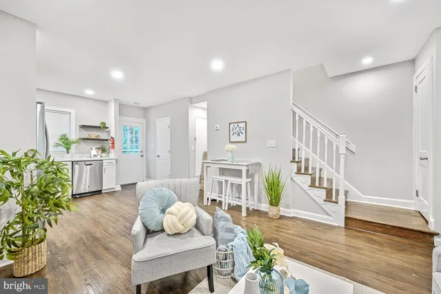 a living room with furniture and wooden floor