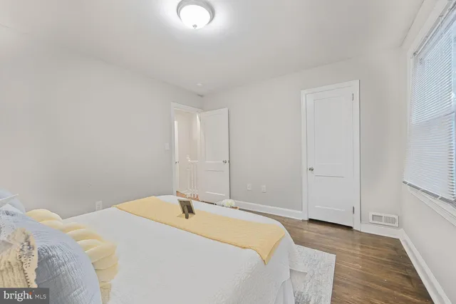 a spacious bedroom with a bed and a table