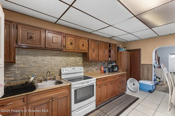 a kitchen with a stove and a refrigerator