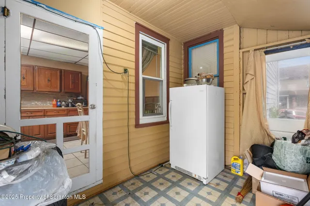 a living room with a bed and a window