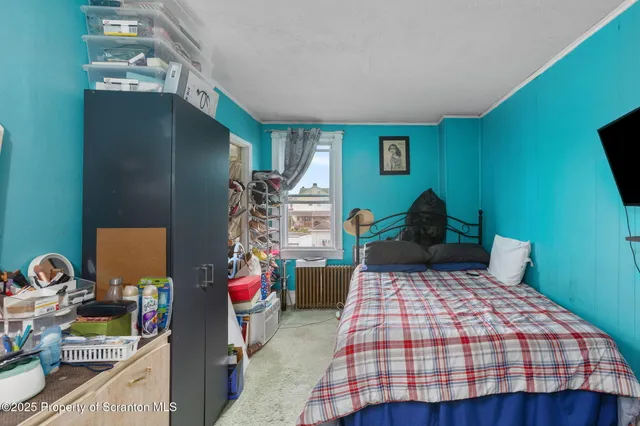 a bedroom with a bed and dresser