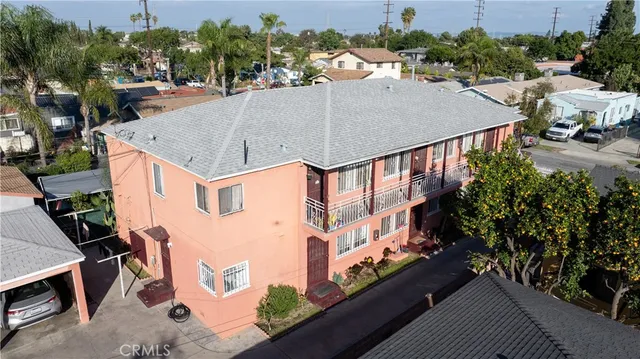 an aerial view of a house with swimming pool and seating space