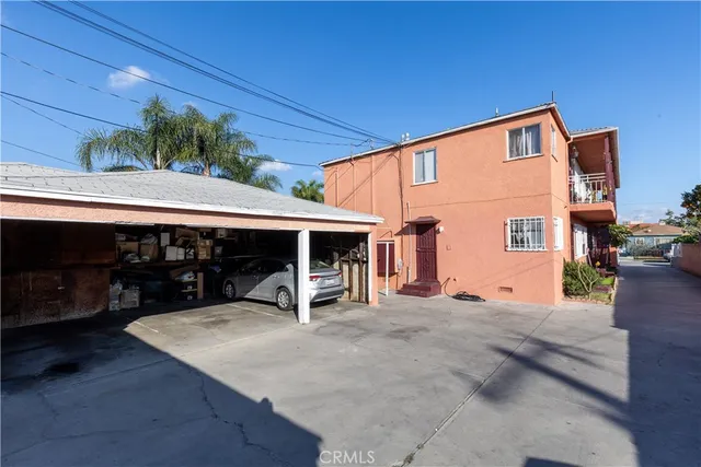 a view of a house with a patio and a yard