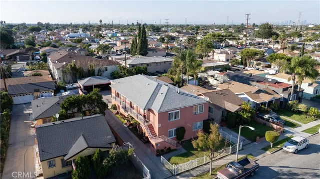 an aerial view of a house with a yard garage and lake view in back