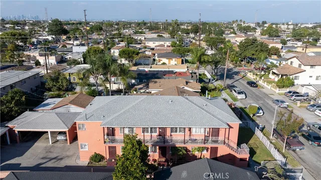 an aerial view of multiple houses with a yard