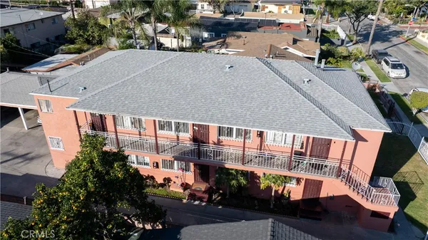 an aerial view of multiple houses with yard