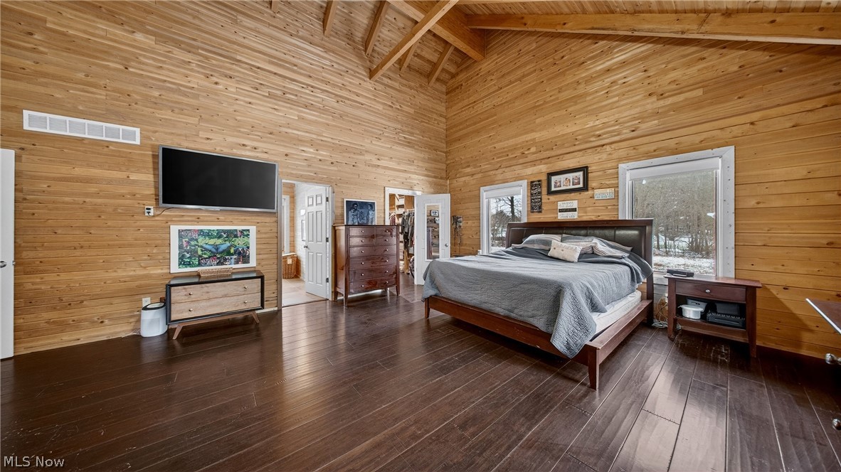 1693 Middleton Road Hudson, OH 44236 - Photo 17 of 48 Bedroom featuring wooden walls, wood-type flooring, and a high wood beamed ceiling