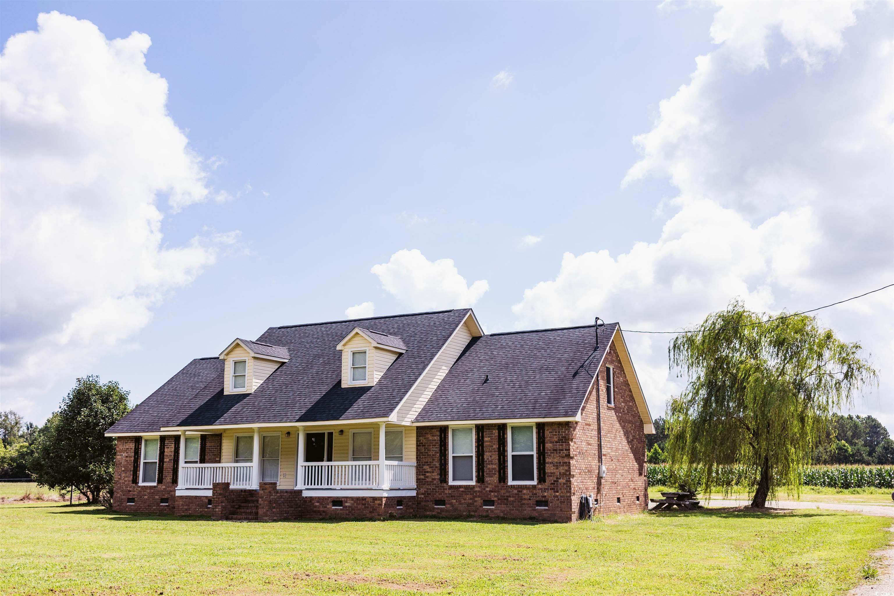 Cape cod house featuring crawl space, a porch, a front yard, and a shingled roof
