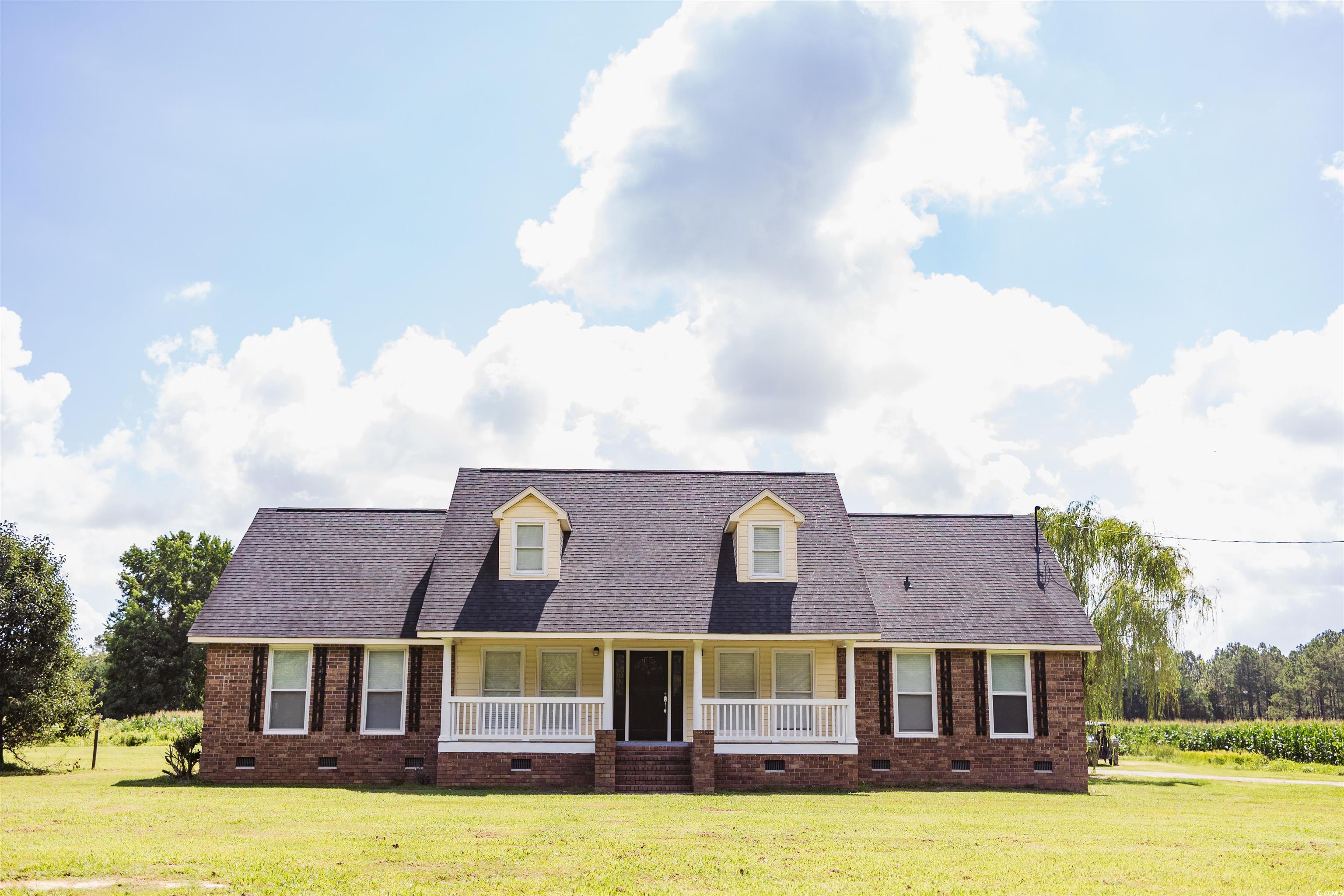 2851 Highway 984 Galivants Ferry, SC 29544 - Photo 2 of 23 New england style home featuring crawl space, brick siding, and a porch