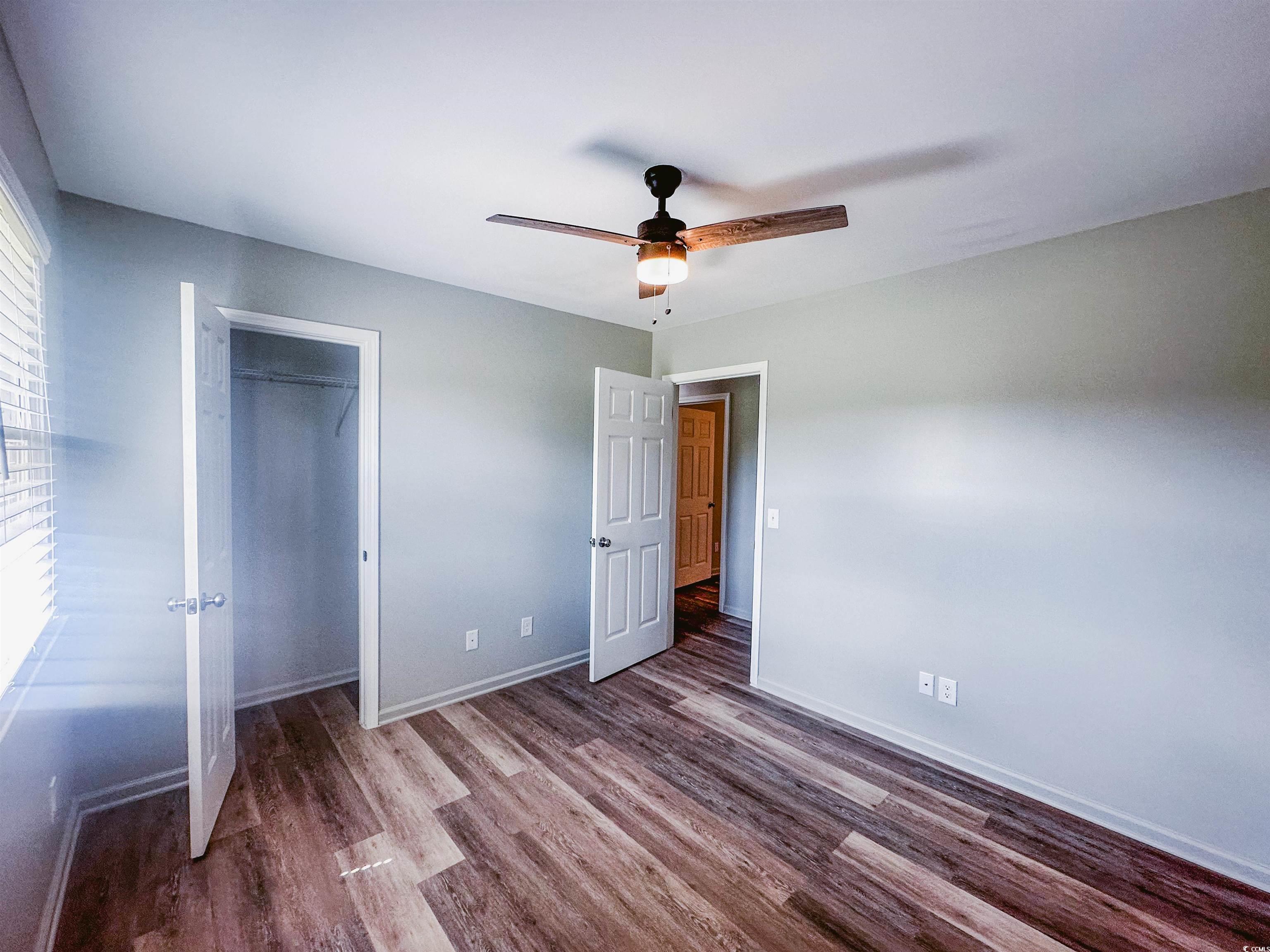 2851 Highway 984 Galivants Ferry, SC 29544 - Photo 9 of 23 Unfurnished bedroom with wood finished floors, a ceiling fan, and a closet