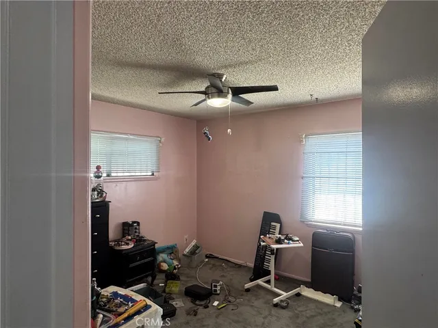 a room with gym equipment and wooden floor