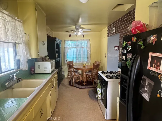 a kitchen that has a sink a stove and a table