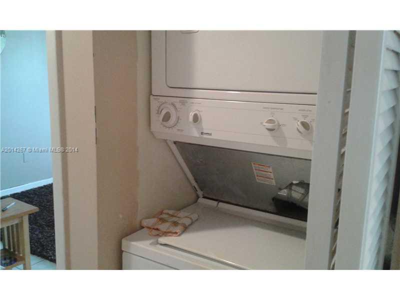 9702 Southwest 138th Avenue, Unit 9702 Miami, FL 33186 - Photo 13 of 15 a bathroom with a sink and a mirror