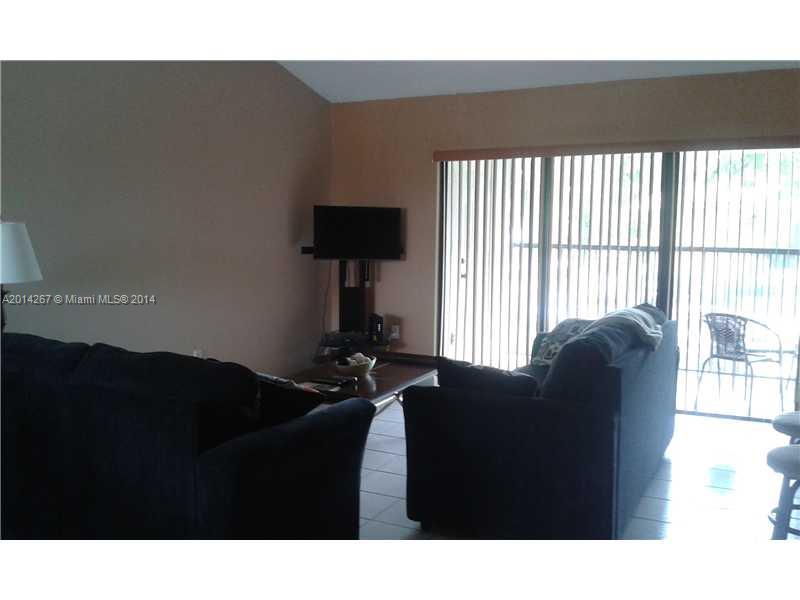 9702 Southwest 138th Avenue, Unit 9702 Miami, FL 33186 - Photo 5 of 15 a black and white photo of a living room