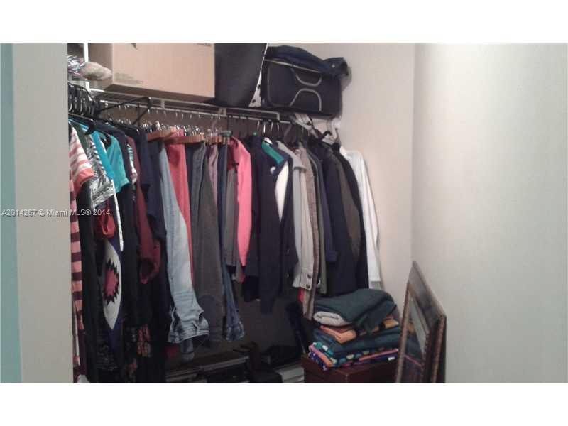 9702 Southwest 138th Avenue, Unit 9702 Miami, FL 33186 - Photo 9 of 15 a view of walk in closet with clothes