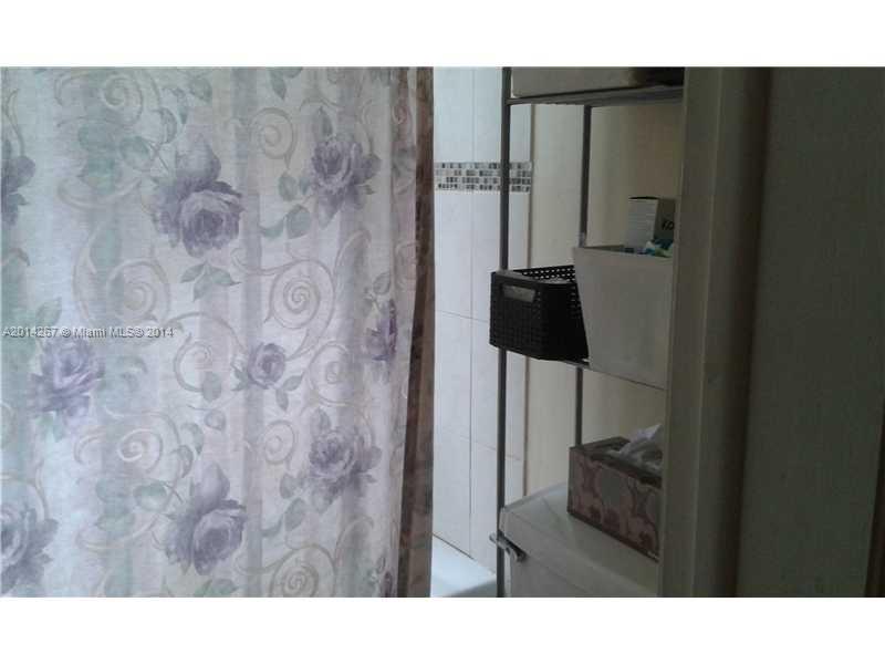 9702 Southwest 138th Avenue, Unit 9702 Miami, FL 33186 - Photo 10 of 15 a bathroom with a sink and mirror