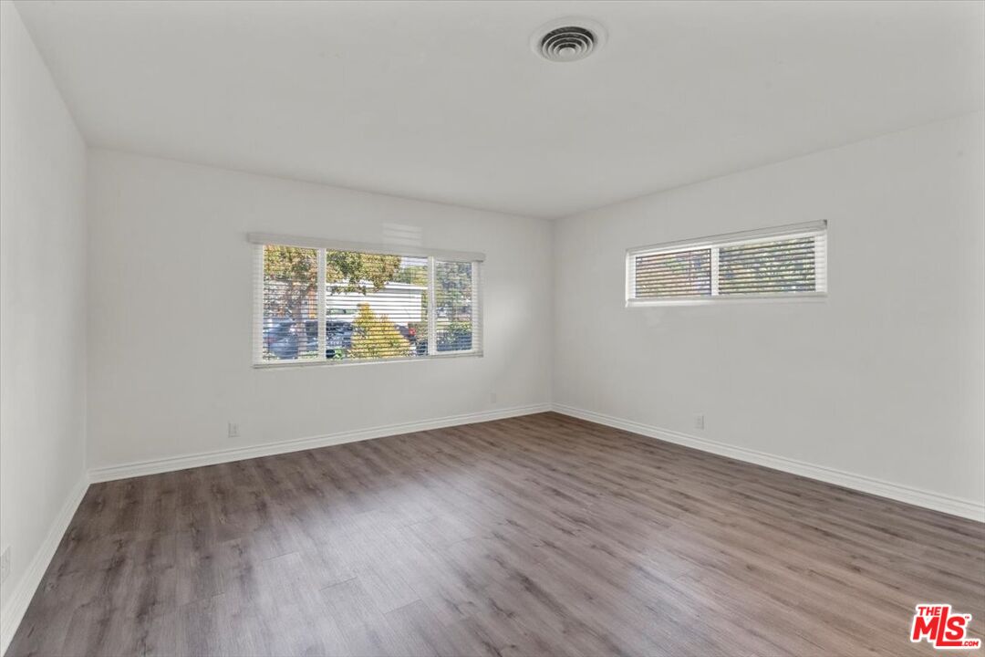 262 MacDonald Street Pasadena, CA 91103 - Photo 14 of 26 an empty room with wooden floor and window