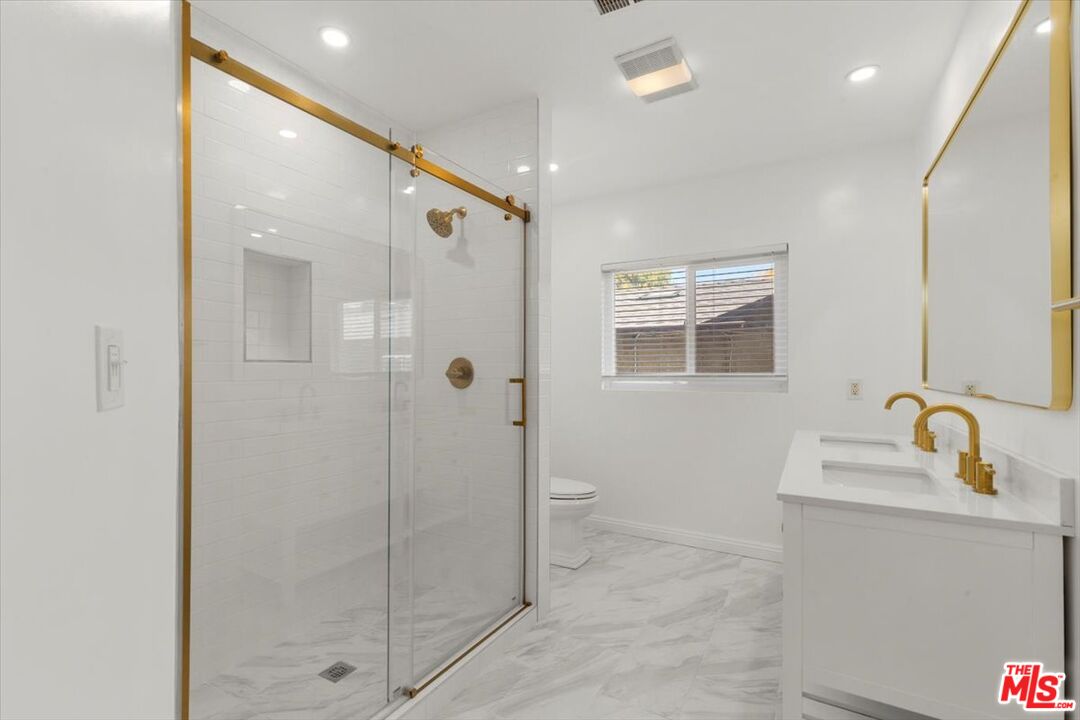 262 MacDonald Street Pasadena, CA 91103 - Photo 15 of 26 a bathroom with a shower sink and mirror
