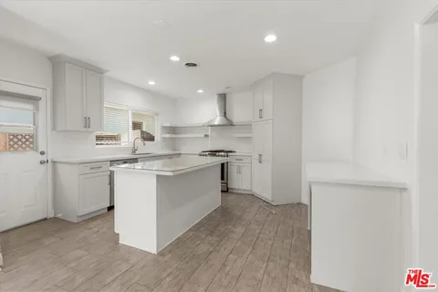 a kitchen with a sink window and cabinets