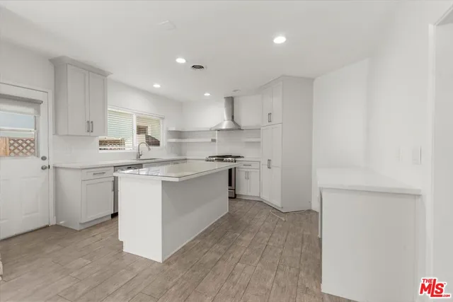 a kitchen with a sink window and cabinets