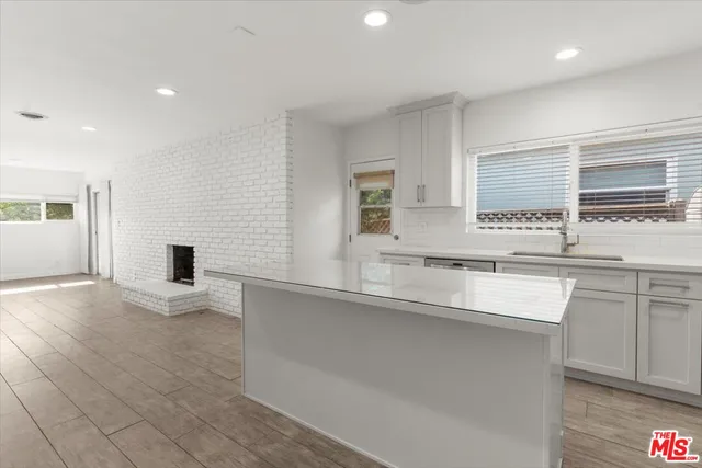 a kitchen with stainless steel appliances granite countertop a sink and a stove