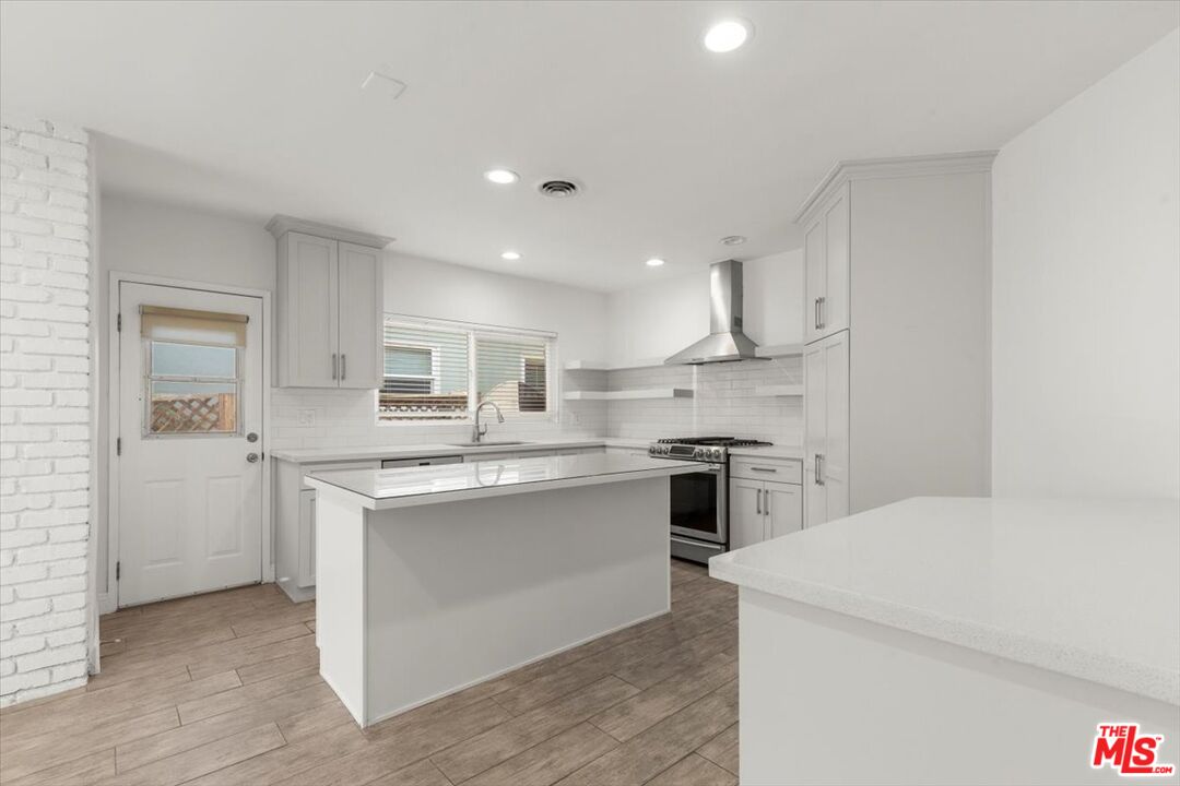 262 MacDonald Street Pasadena, CA 91103 - Photo 6 of 26 a kitchen with a stove a sink and a refrigerator