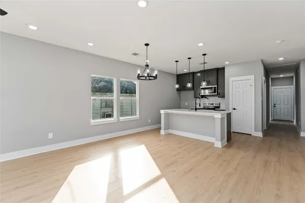 a view of kitchen with sink microwave and refrigerator