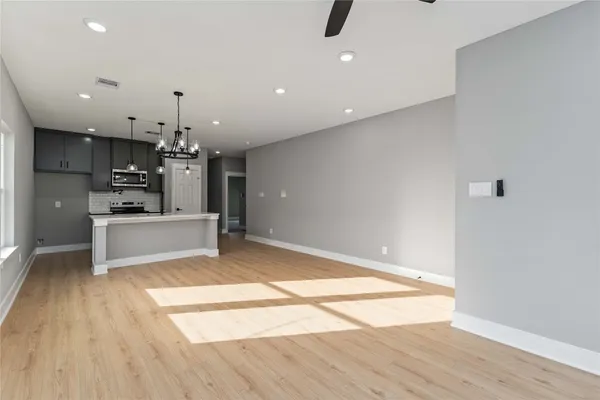 a view of kitchen with refrigerator and microwave
