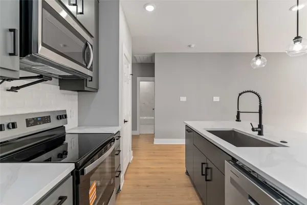 a kitchen that has a sink and a stove
